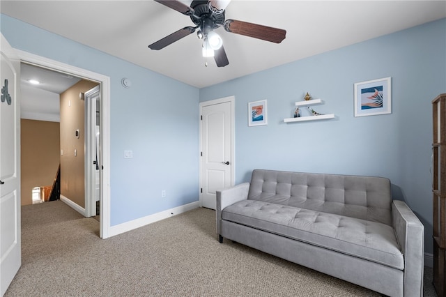 sitting room with ceiling fan and carpet flooring