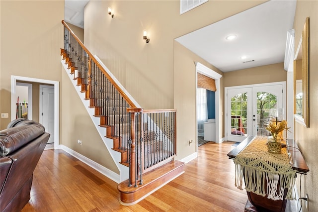 foyer entrance featuring light hardwood / wood-style flooring and french doors