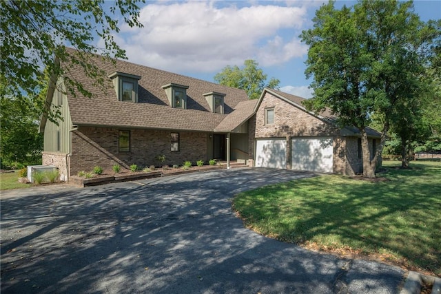 cape cod home featuring a front lawn and a garage