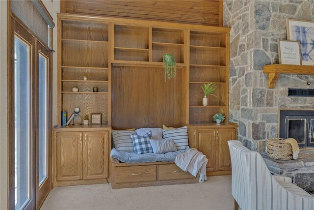 living area with a fireplace and light carpet