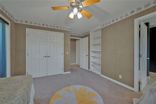 bedroom with ceiling fan and light carpet