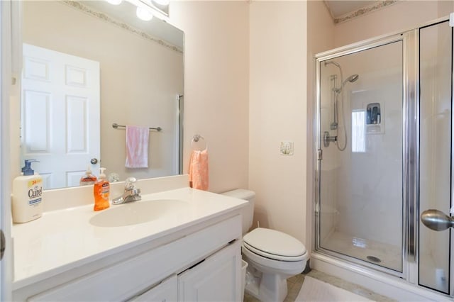 bathroom with an enclosed shower, vanity, and toilet