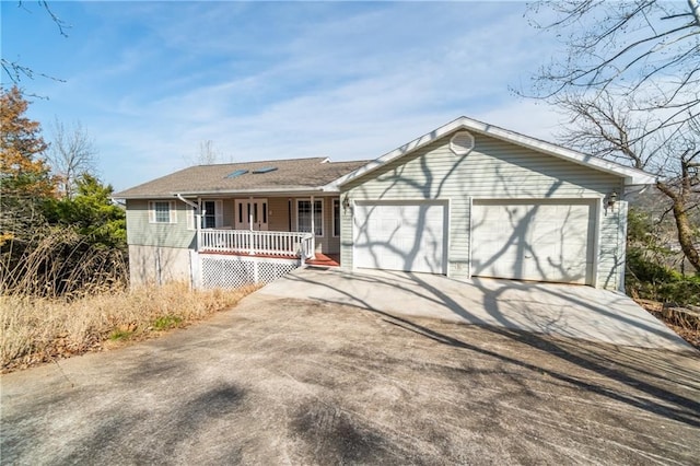 single story home featuring a garage and covered porch