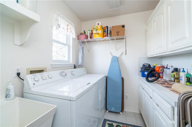 laundry room with cabinets, sink, light tile patterned floors, and independent washer and dryer