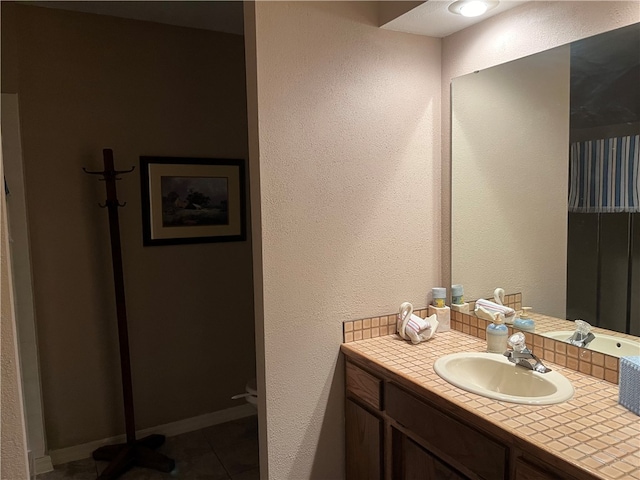 bathroom with tile patterned floors and vanity