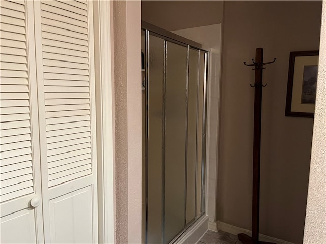 bathroom with a shower with door