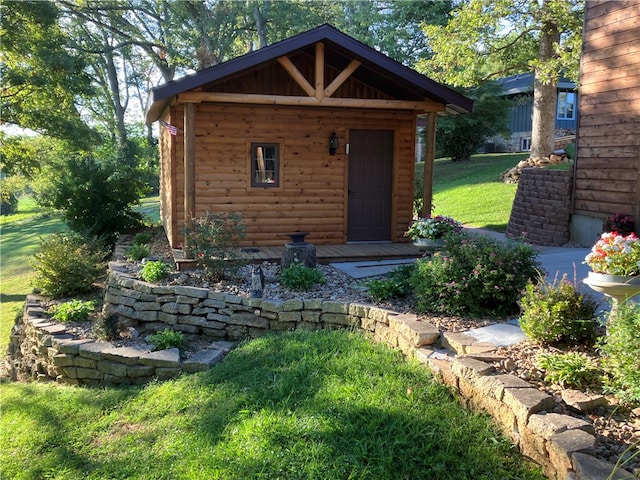 view of outbuilding featuring a lawn