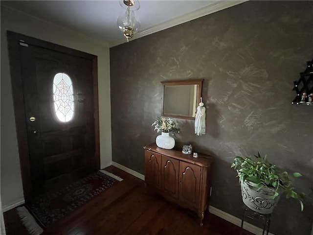 entrance foyer featuring ornamental molding and hardwood / wood-style floors