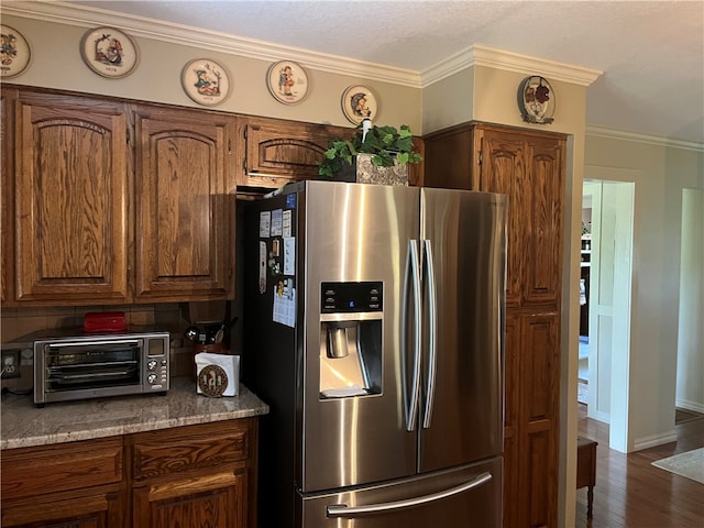 kitchen featuring stainless steel refrigerator with ice dispenser, crown molding, dark hardwood / wood-style flooring, and a textured ceiling