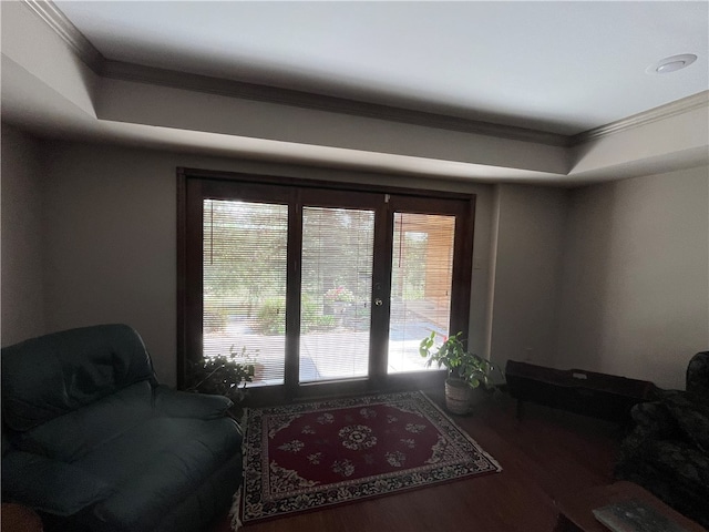 living room with wood-type flooring and crown molding