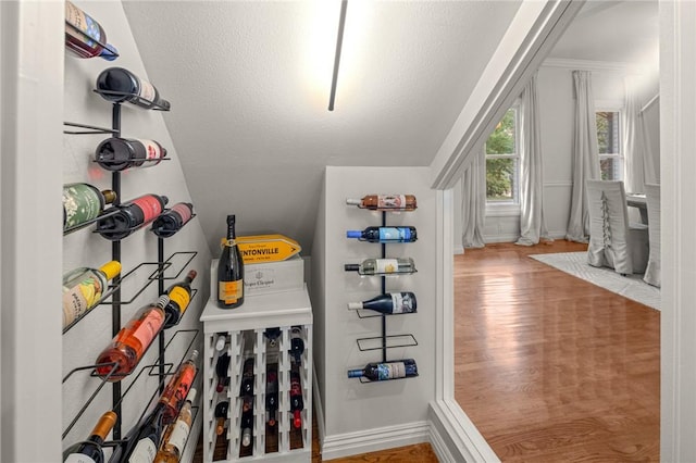 16 W Wimbledon Way, Rogers, AR 72758 - wine room featuring baseboards, vaulted ceiling, and wood finished floors