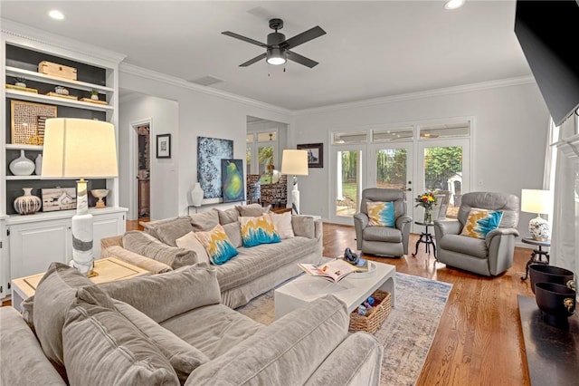 16 W Wimbledon Way, Rogers, AR 72758 - living room featuring light wood-style floors, ornamental molding, a ceiling fan, and visible vents