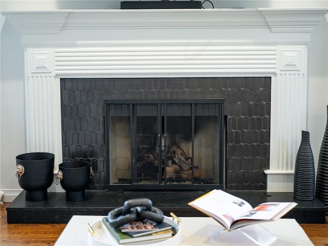 16 W Wimbledon Way, Rogers, AR 72758 - interior details with a fireplace with raised hearth, wood finished floors, and ornamental molding