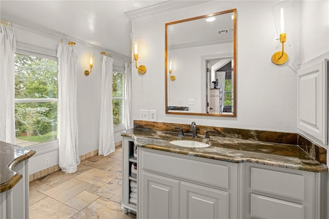 16 W Wimbledon Way, Rogers, AR 72758 - bathroom with crown molding, vanity, stone finish floor, baseboards, and visible vents