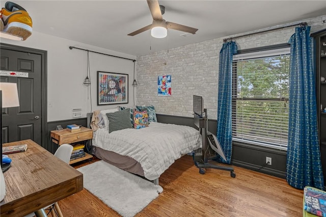 16 W Wimbledon Way, Rogers, AR 72758 - bedroom with brick wall, ceiling fan, and wood finished floors
