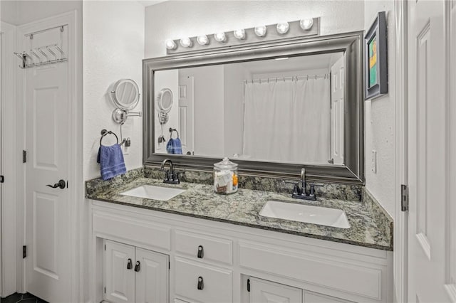 16 W Wimbledon Way, Rogers, AR 72758 - full bathroom featuring a sink, a textured wall, and double vanity