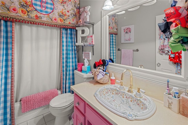 full bathroom with shower / tub combo with curtain, tile patterned floors, vanity, and toilet