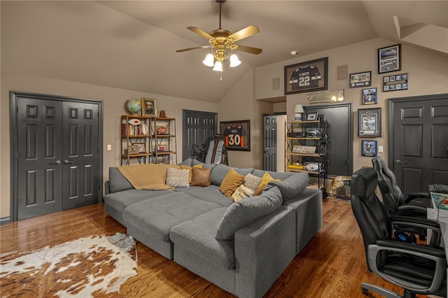 living room featuring wood-type flooring, lofted ceiling, and ceiling fan