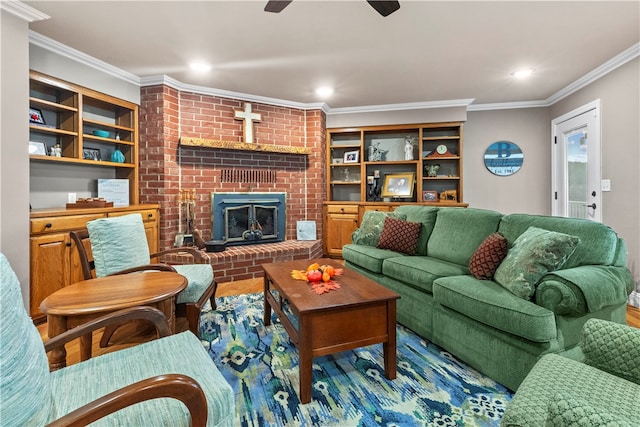 living room featuring crown molding, a fireplace, and hardwood / wood-style floors