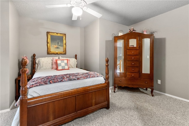 carpeted bedroom with ceiling fan and a textured ceiling