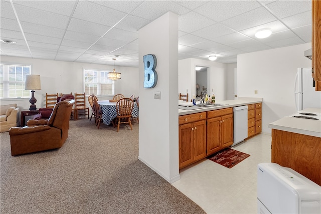 kitchen featuring a wealth of natural light, a drop ceiling, pendant lighting, and white appliances