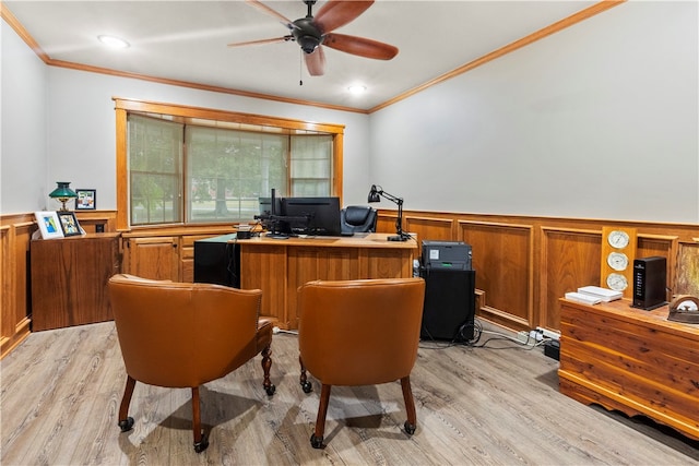 home office with built in desk, light hardwood / wood-style flooring, and crown molding