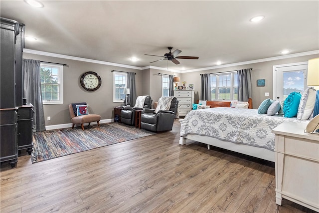 bedroom with multiple windows, ceiling fan, and hardwood / wood-style flooring