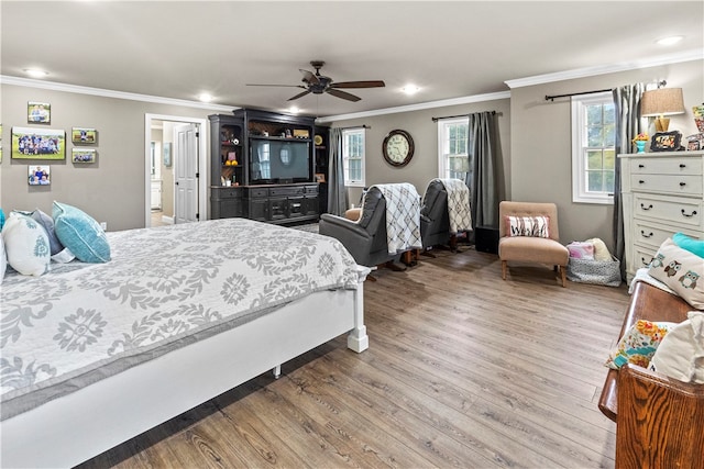 bedroom with hardwood / wood-style floors, ceiling fan, ensuite bathroom, and crown molding