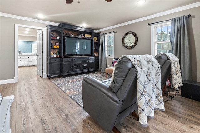 living room with hardwood / wood-style floors, ceiling fan, and ornamental molding