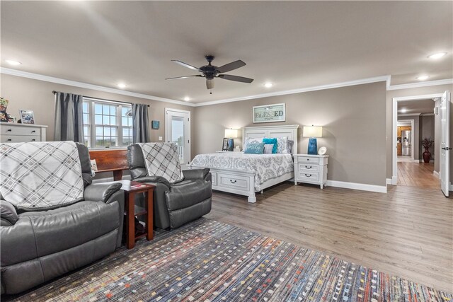 bedroom featuring dark hardwood / wood-style floors, ceiling fan, and crown molding