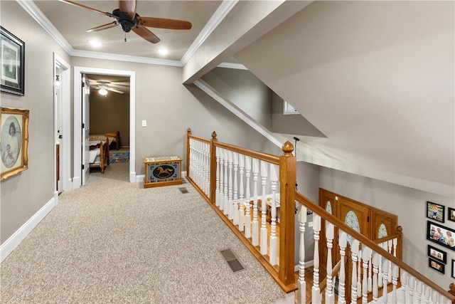 hall featuring carpet floors and ornamental molding