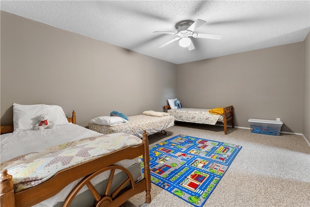 bedroom featuring carpet, a textured ceiling, and ceiling fan