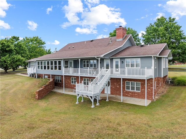 back of property featuring a patio area and a yard