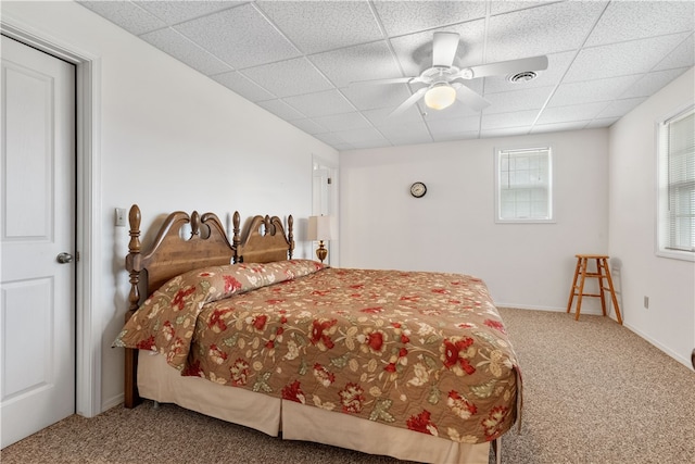 carpeted bedroom featuring a paneled ceiling and ceiling fan