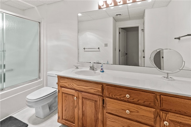 full bathroom featuring combined bath / shower with glass door, vanity, and toilet