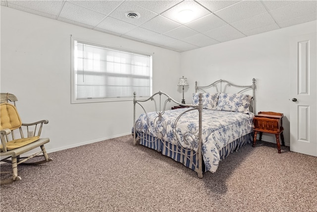 bedroom with a paneled ceiling and carpet