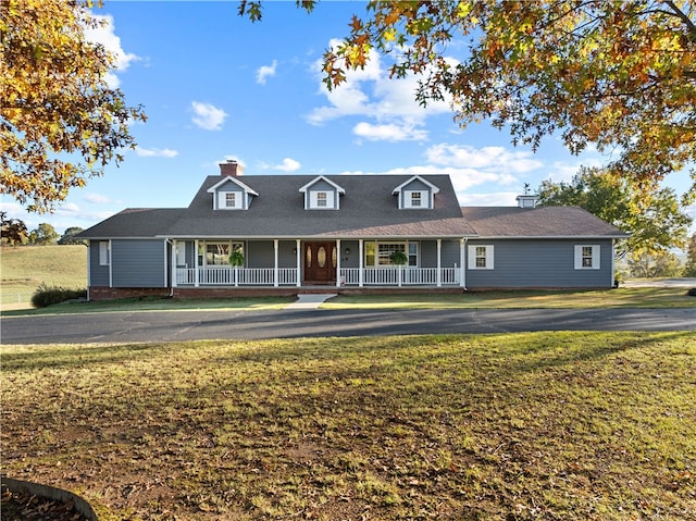 view of front of house with a porch and a front yard