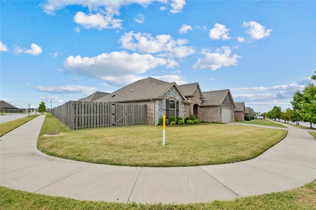 view of front facade with a front yard and a garage