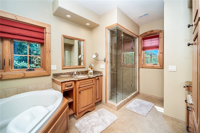 bathroom with independent shower and bath, vanity, and tile patterned floors