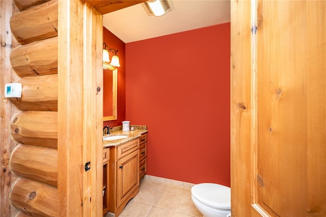 bathroom featuring tile patterned floors, vanity, and toilet