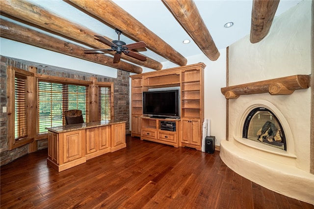 unfurnished living room with ceiling fan, beamed ceiling, and dark hardwood / wood-style floors