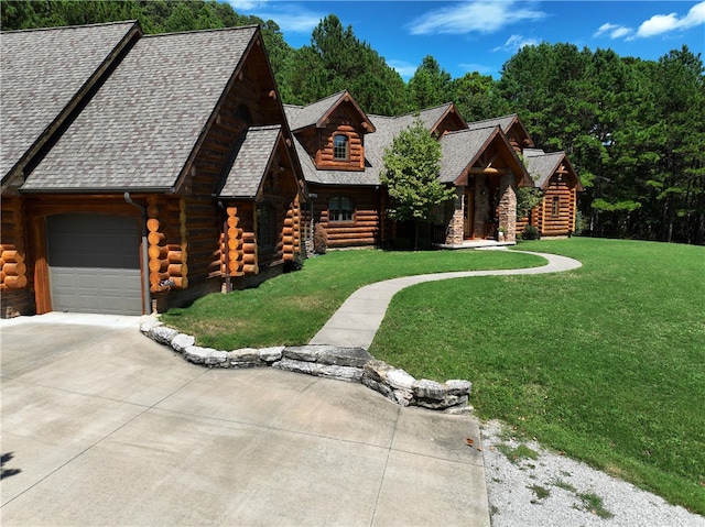 cabin featuring a front yard and a garage