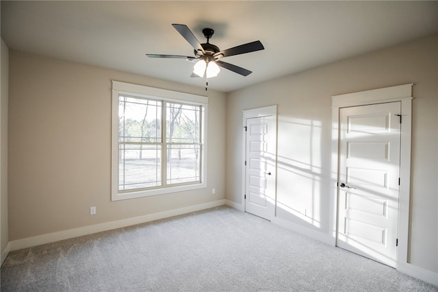 unfurnished bedroom featuring light carpet and ceiling fan