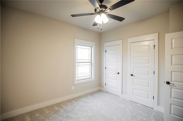 unfurnished bedroom with light colored carpet and ceiling fan