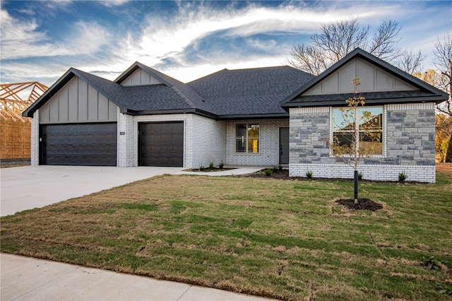 view of front of home featuring a garage and a front lawn