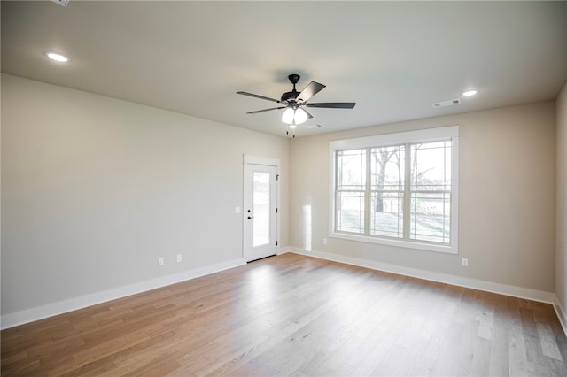 spare room with light hardwood / wood-style flooring and ceiling fan