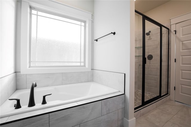 bathroom with independent shower and bath, tile patterned flooring, and plenty of natural light