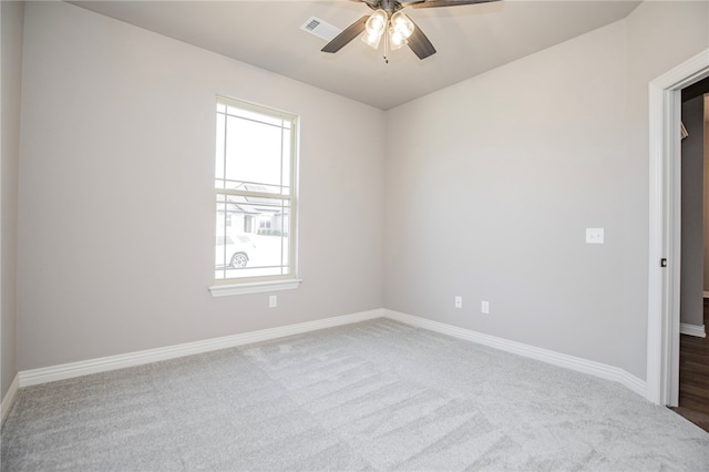 carpeted spare room with ceiling fan