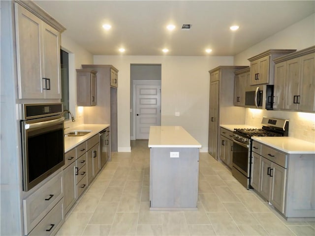 kitchen with backsplash, a center island, recessed lighting, stainless steel appliances, and a sink