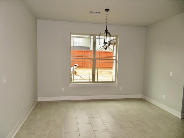 unfurnished dining area with visible vents, baseboards, and a notable chandelier